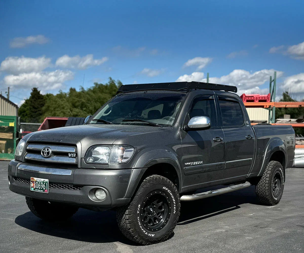 Toyota Tundra TRD pickup truck with off-road tires and roof rack in outdoor lot