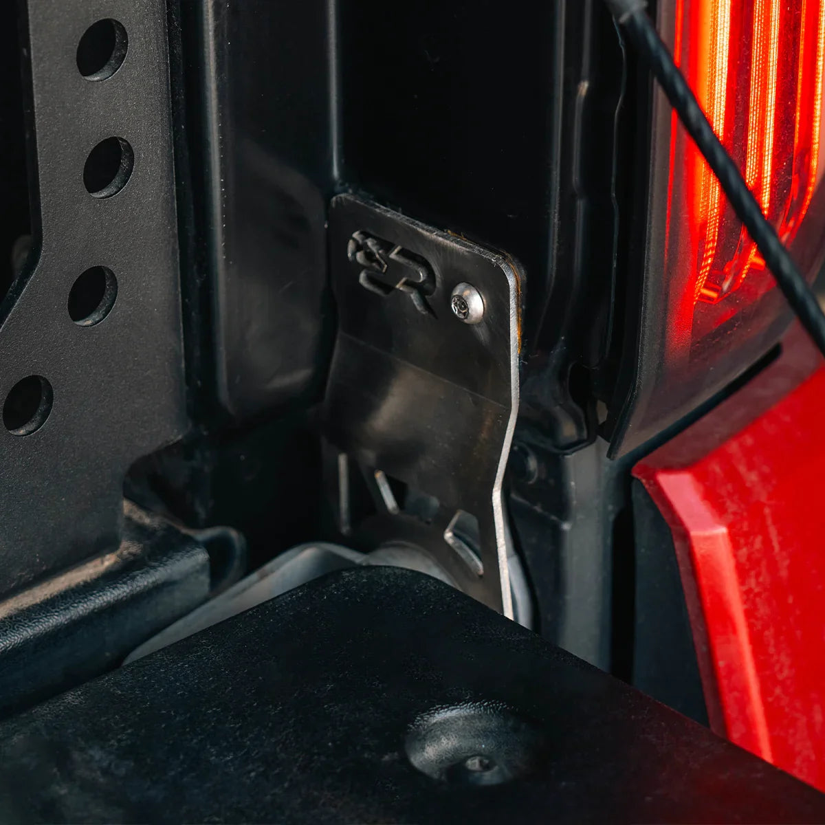 Tailgate theft protector installed on 2024 Toyota Tacoma rear tailgate latch area