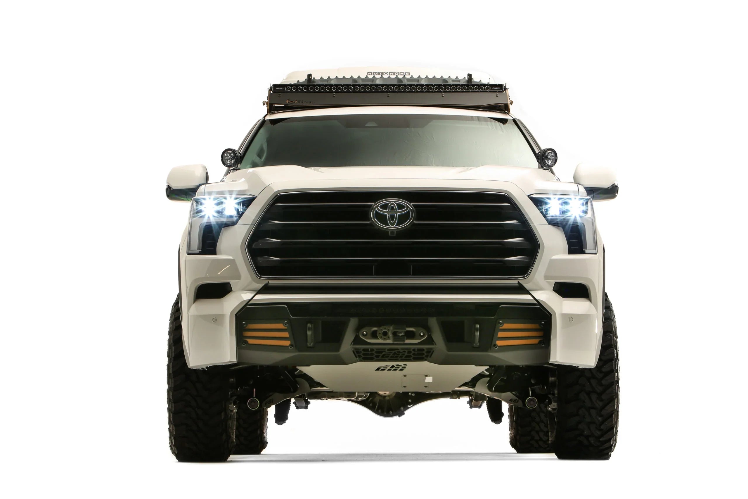 Front view of modified white Toyota Sequoia TRD with off-road accessories and LED lights