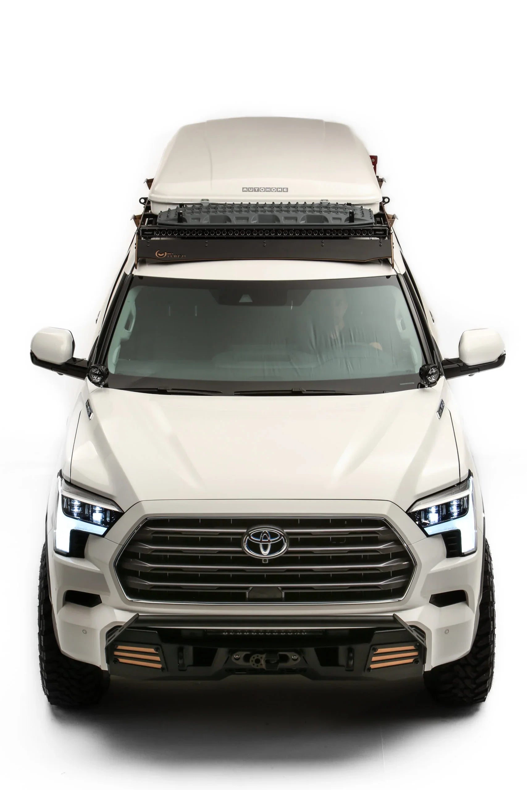 Front view of white Toyota Sequoia TRD Off-Road with roof rack and overlanding gear