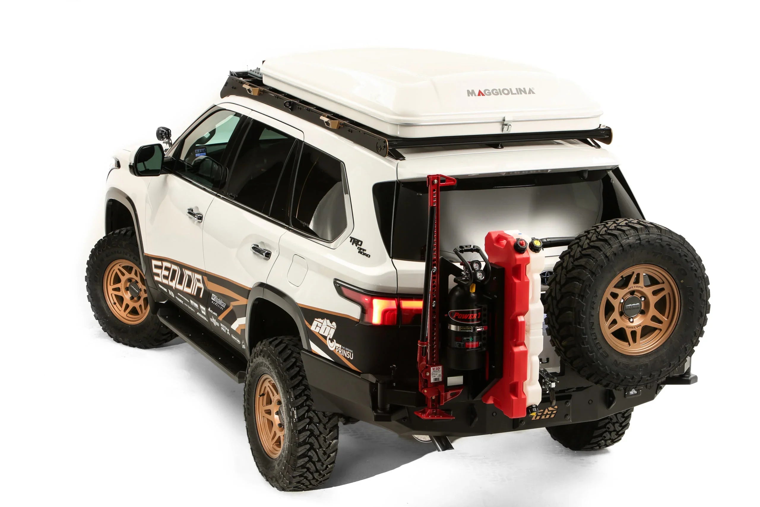 Toyota Sequoia TRD Offroad overlanding SUV with rooftop tent, off-road tires, and expedition gear.