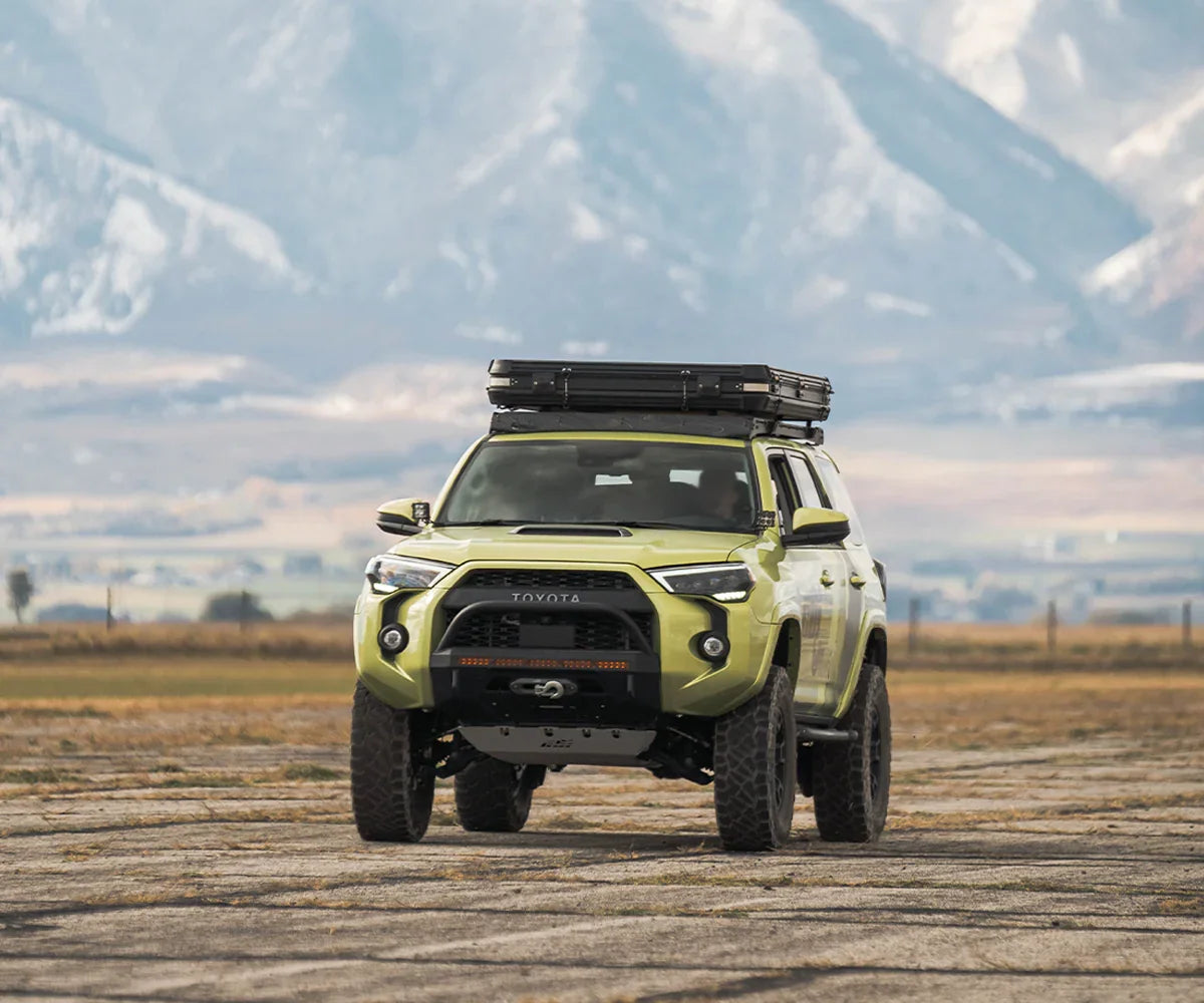 Toyota 4Runner with covert front bumper and roof rack in an outdoor mountain setting