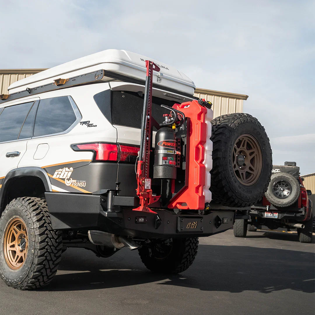 Toyota Sequoia with rear swing arm add-on carrying spare tire, fuel can, and gear for overlanding.