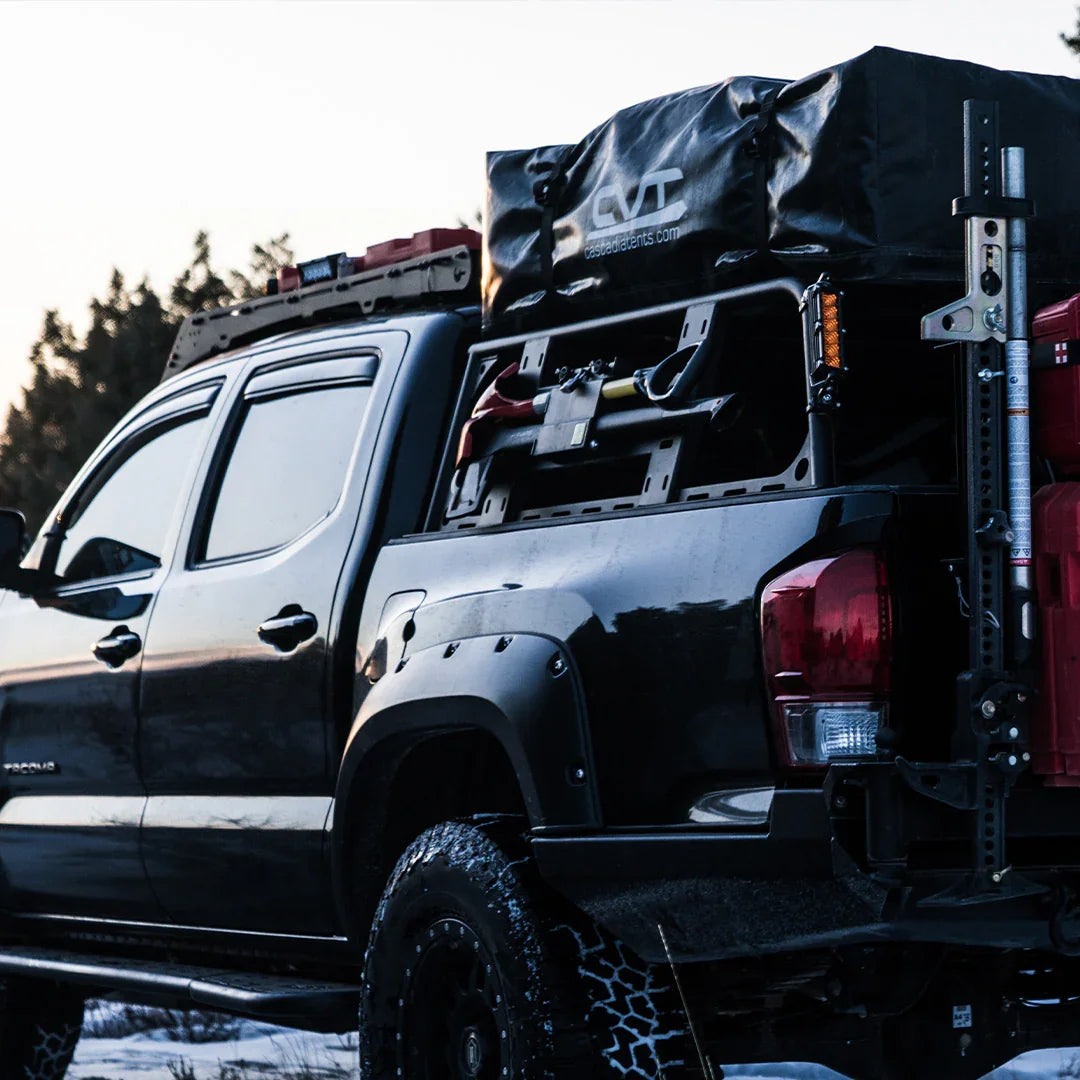 Toyota Tacoma with overland bed rack, cargo gear, rooftop tent, and off-road accessories