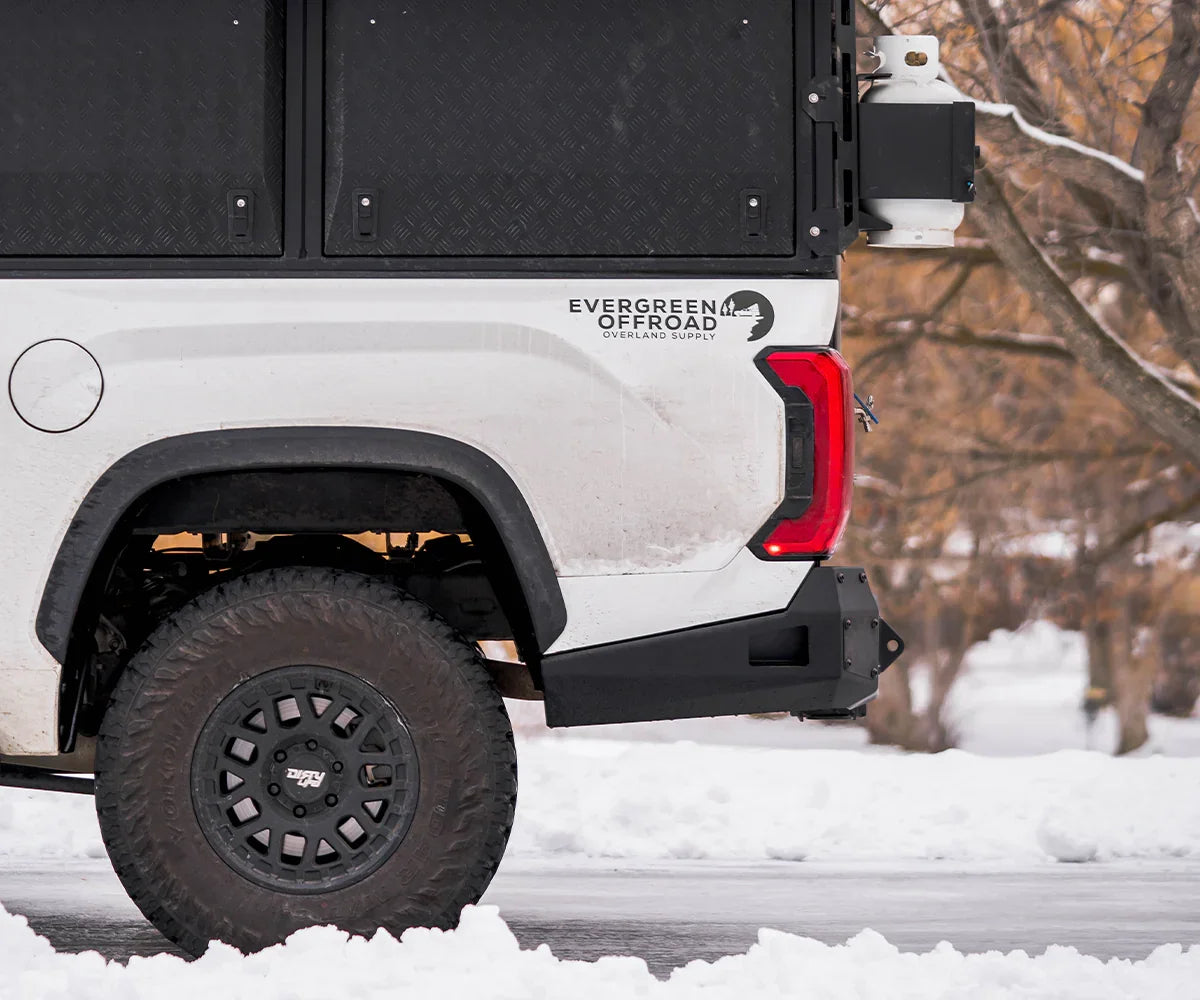 Toyota Tundra 2022-2023 rear bumper with off-road modifications and snow background