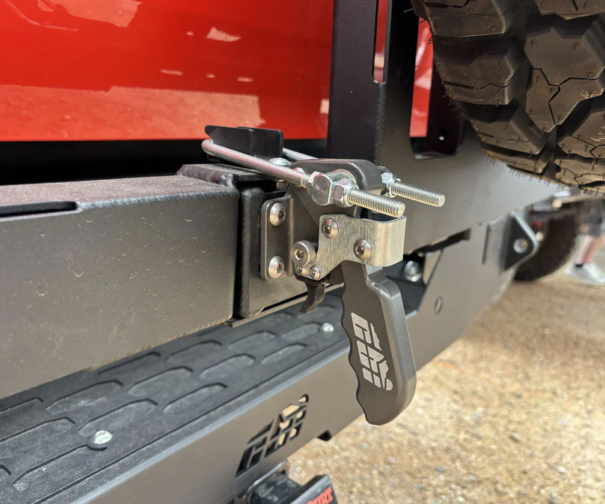 Close-up of heavy-duty tailgate latch and tire mount on Toyota Tundra off-road bumper