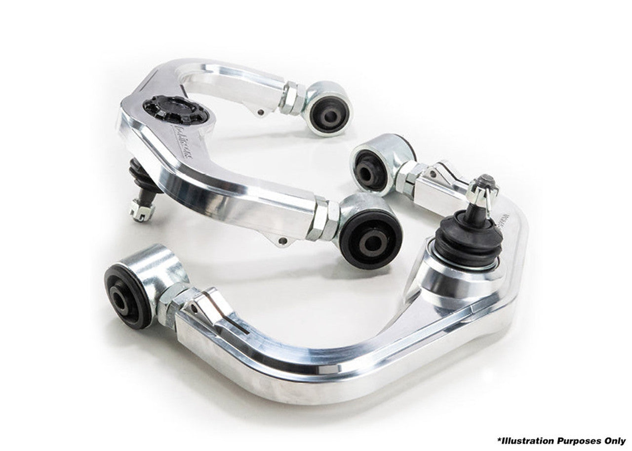 Billet aluminum upper control arms for off-road trucks and SUVs, isolated on white background.