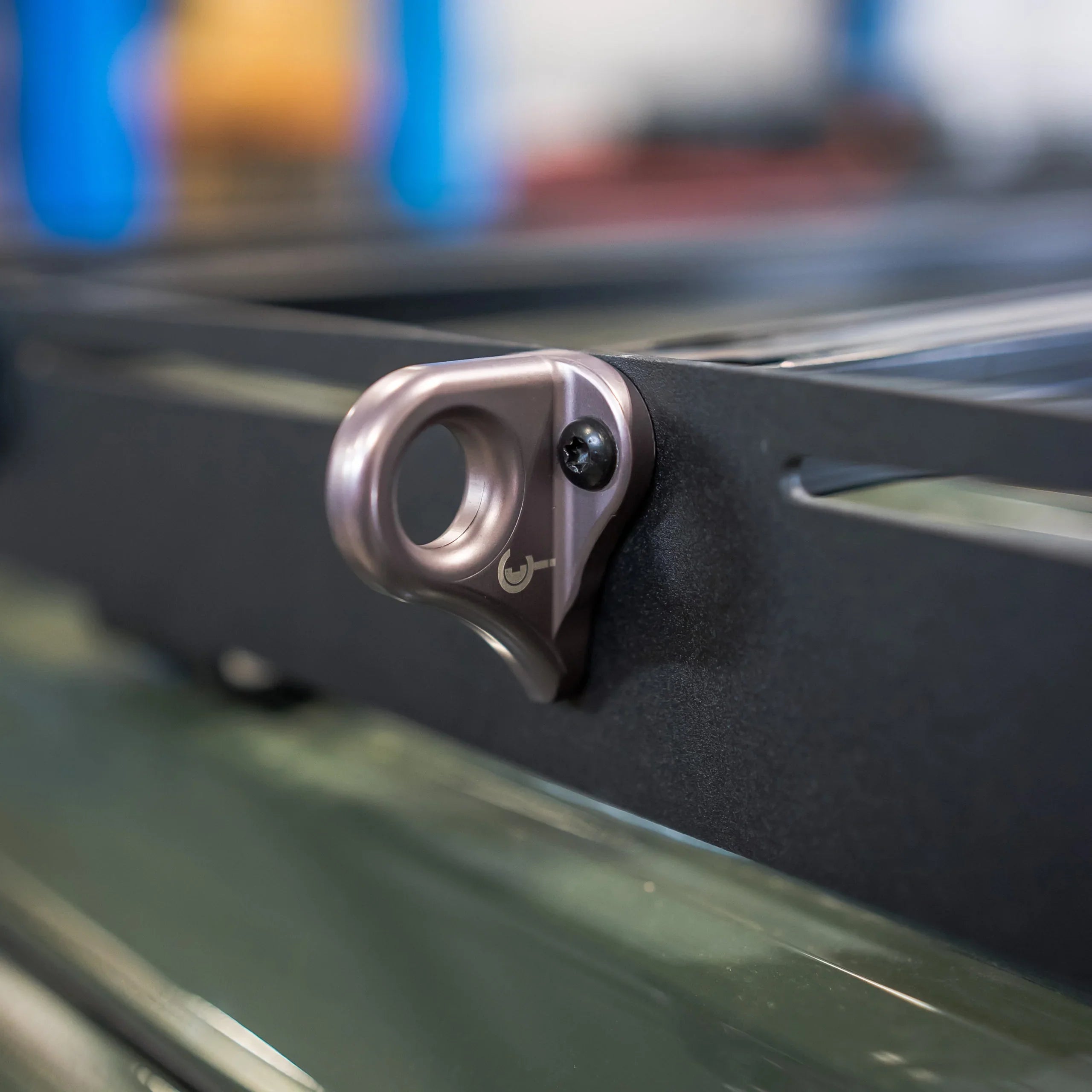 Aluminum utility hook mount attached to a vehicle roof rack for overlanding gear