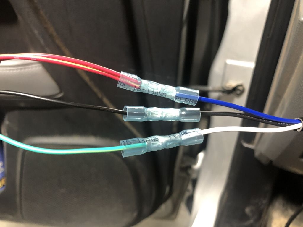 Close-up of connected color-coded wires with crimp connectors in a Toyota vehicle interior