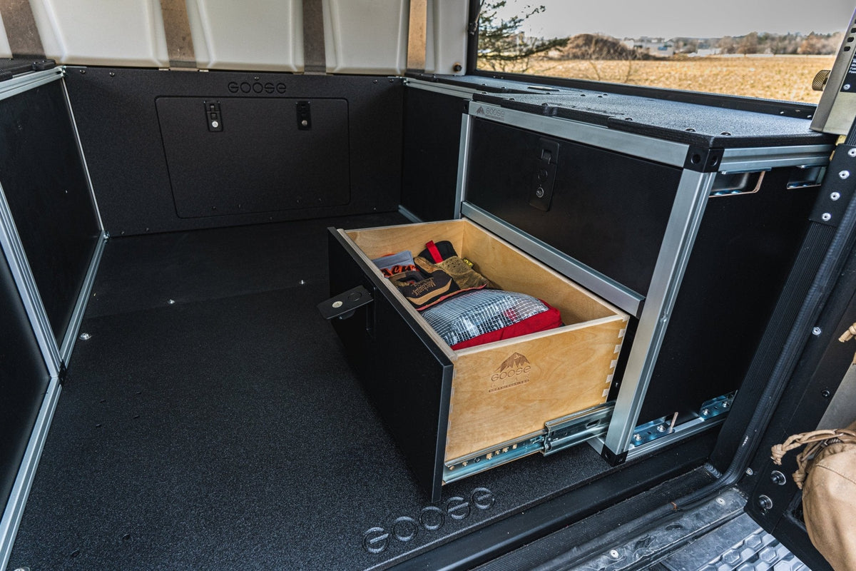 Goose Gear rear double drawer module in an Alu-Cab Canopy Camper on a Tacoma, top drawer open with gear inside