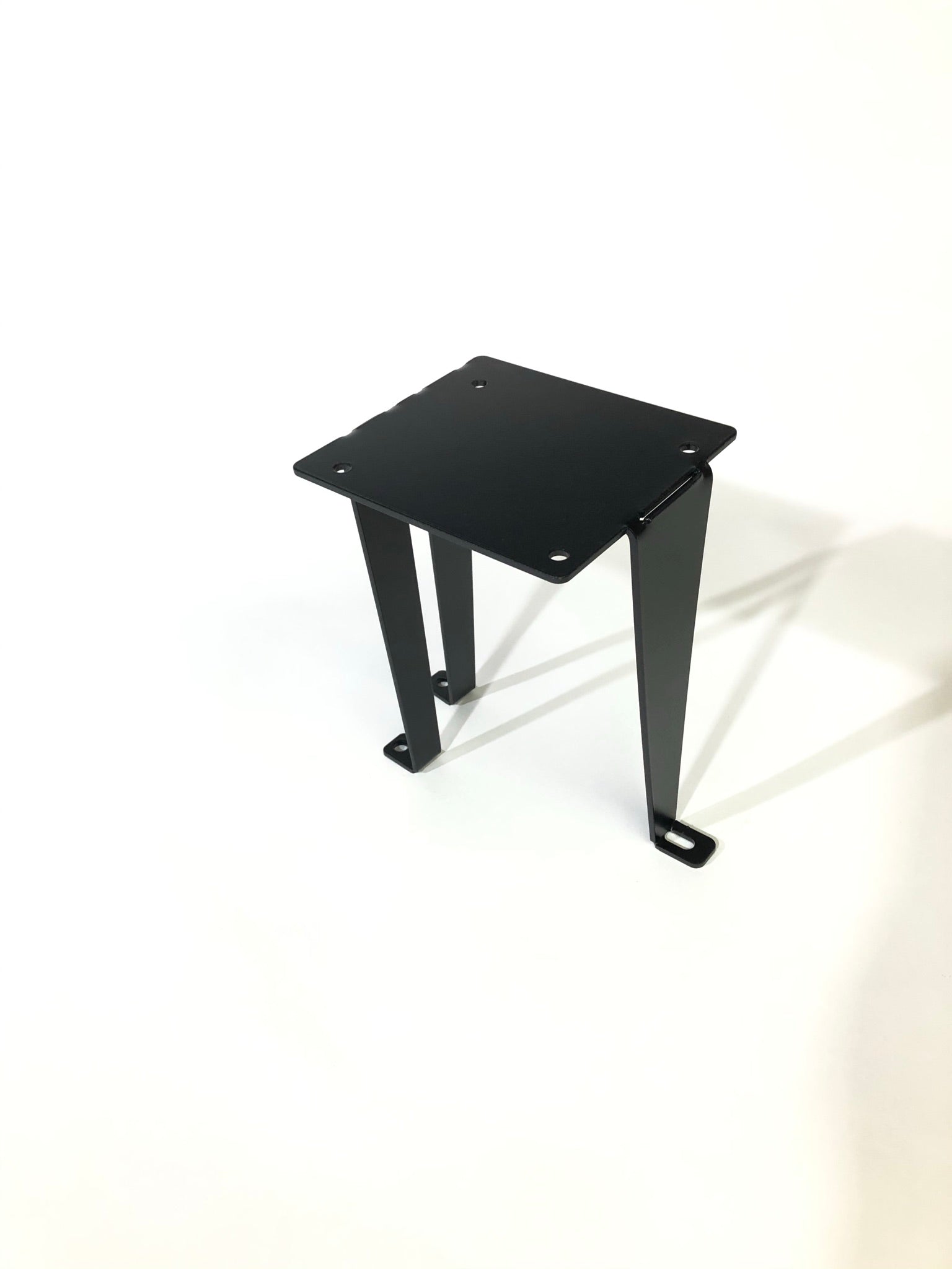 Black ARB tank mounting bracket with four mounting holes, designed for Toyota Tundra