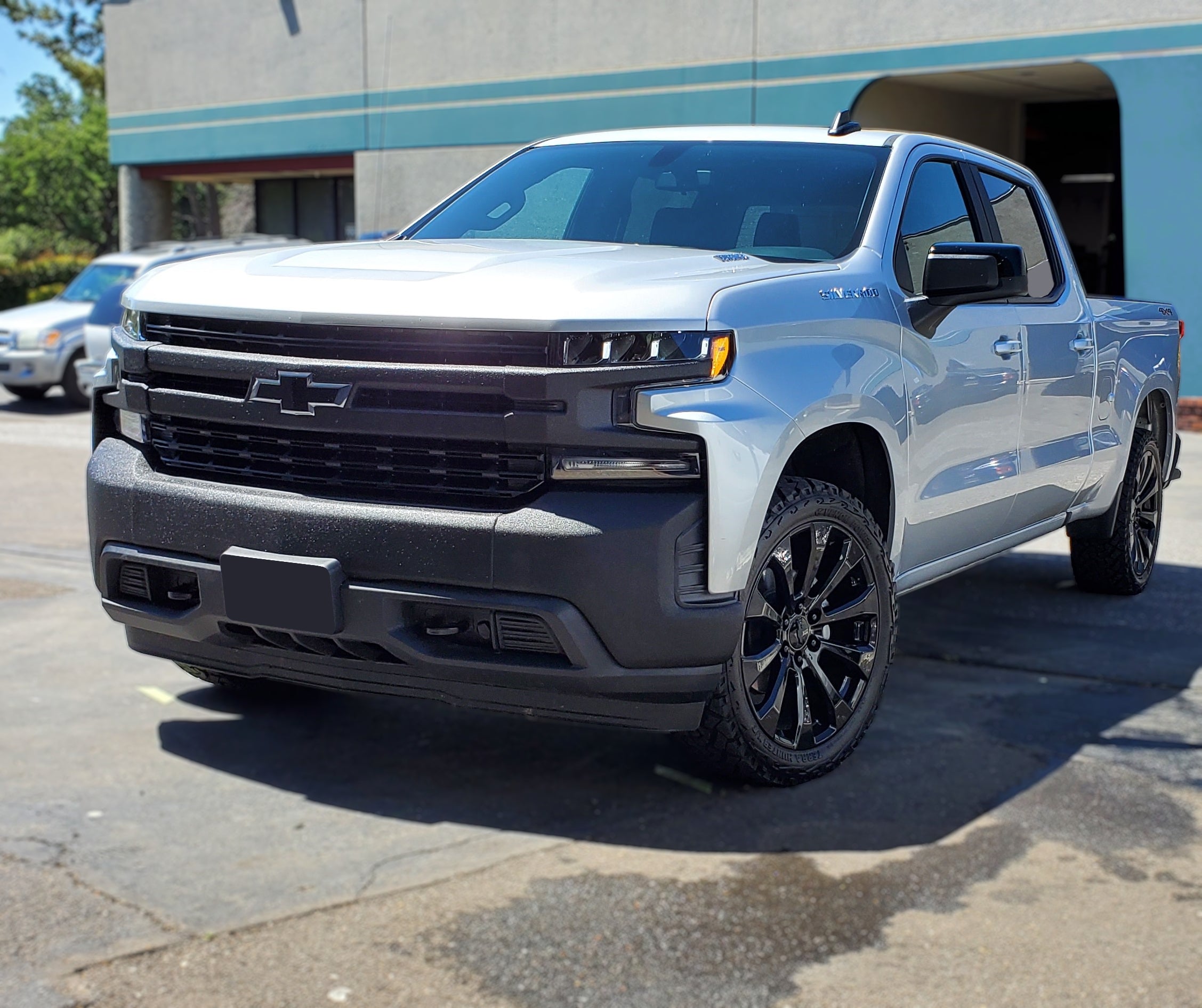 White 2019-2020 Silverado 1500 LT/LTZ equipped with an armor-coated Grille Overlay, demonstrating the rugged and tough visual appeal