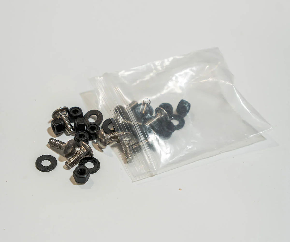 Assorted metal bolts, washers, and nuts for vehicle accessories on a white background
