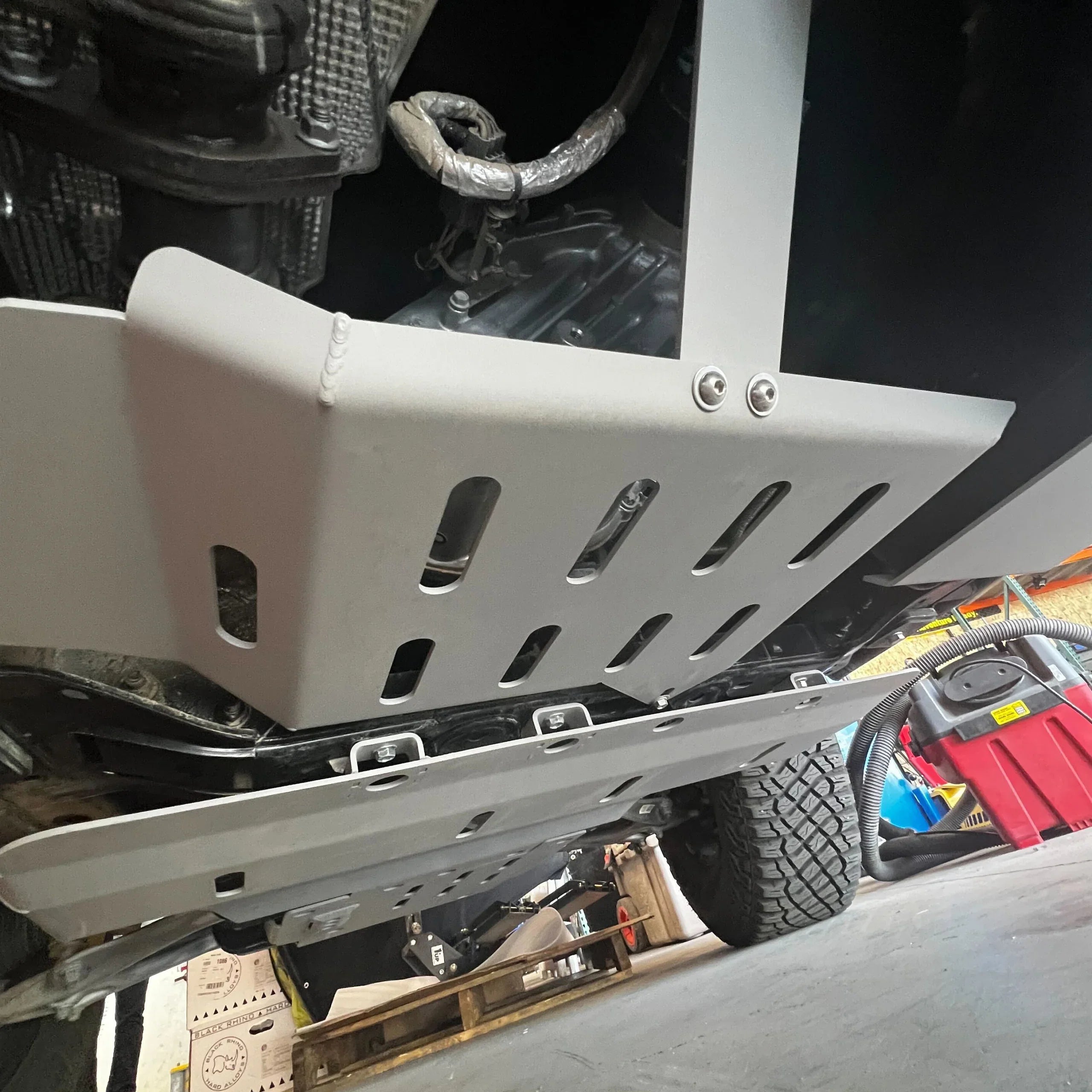 Close-up of Ford Bronco transfer case skid plate installed, off-road protection accessory