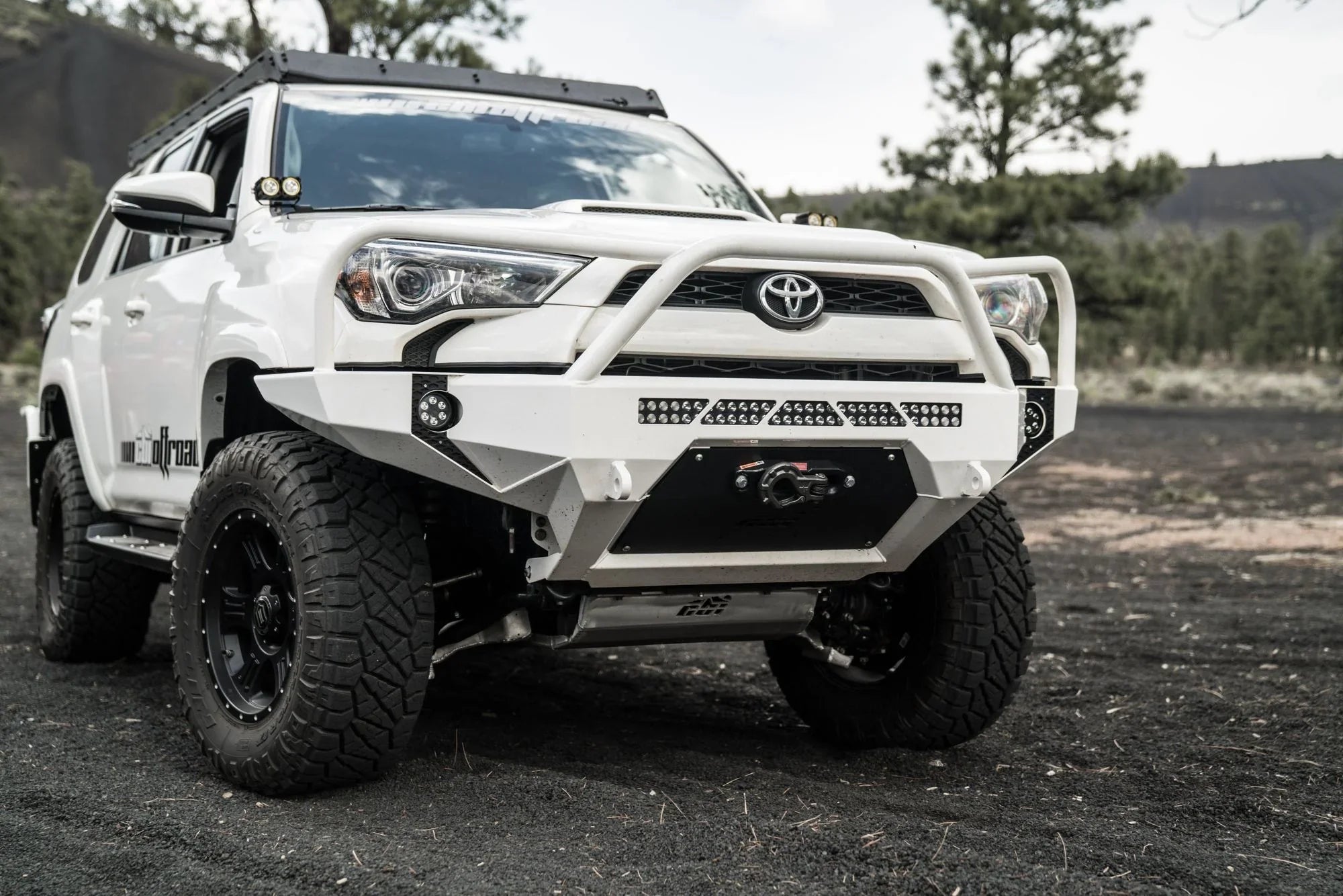 Toyota 4Runner with off-road front bumper, winch, LED lights, and rugged tires outdoors