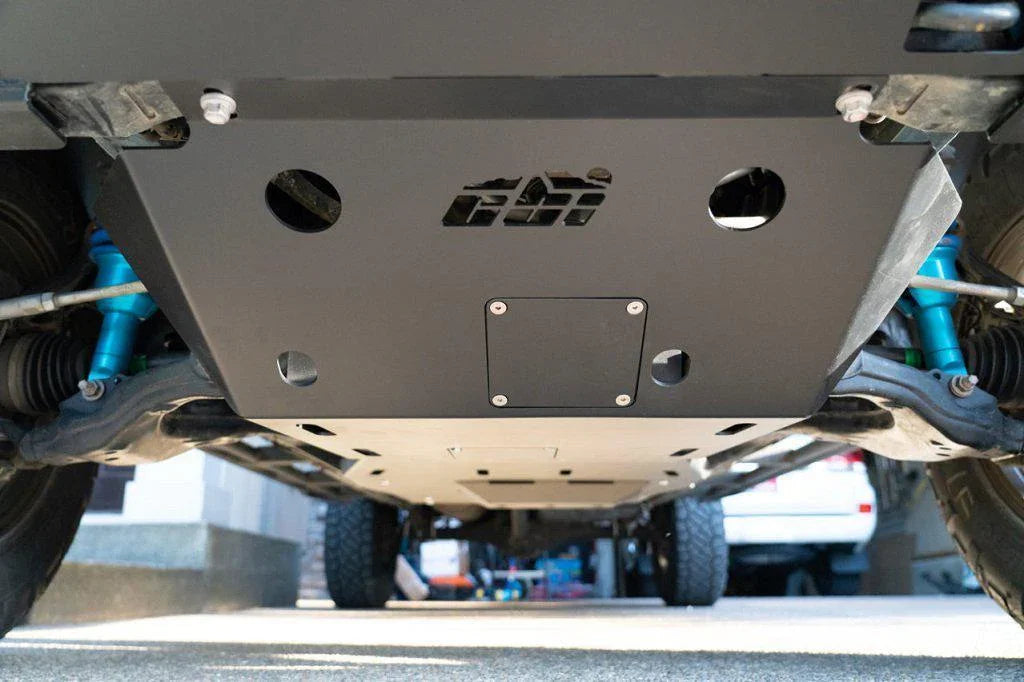 Steel front skid plate installed under Toyota Tacoma, protecting the undercarriage.