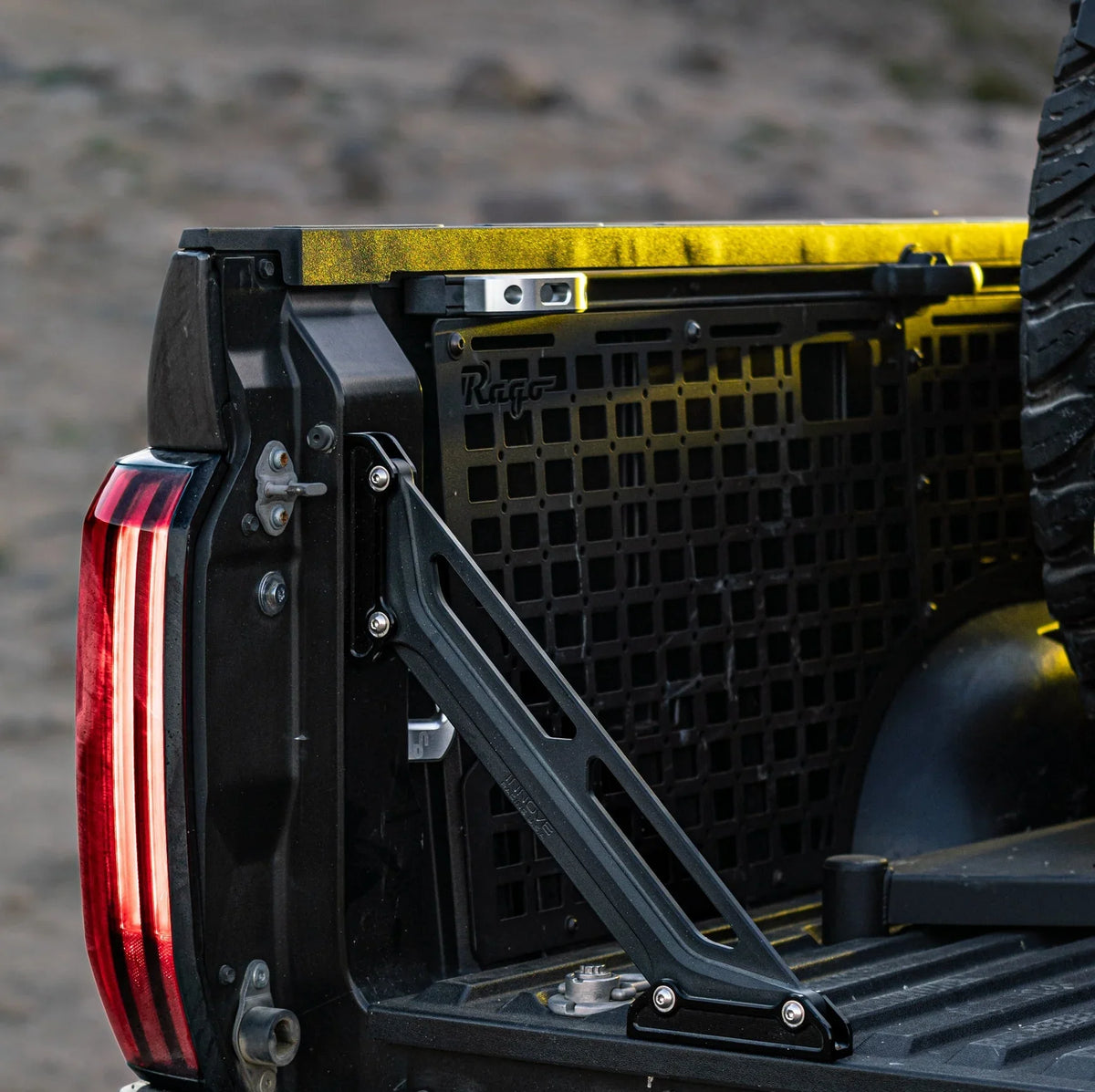 Overland bed rail accessory and gear mounting panel on pickup truck tailgate