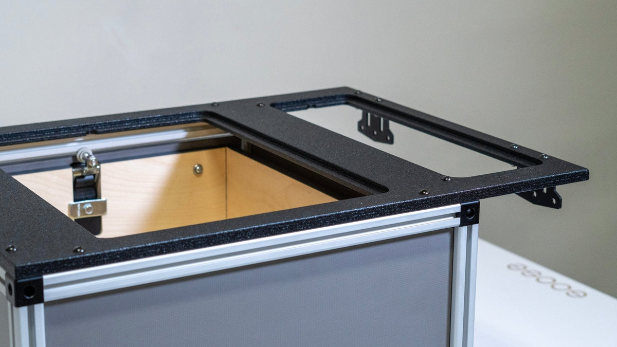 Close-up of the Goose Gear front utility module's open top frame, wood-lined cavity and rail hardware
