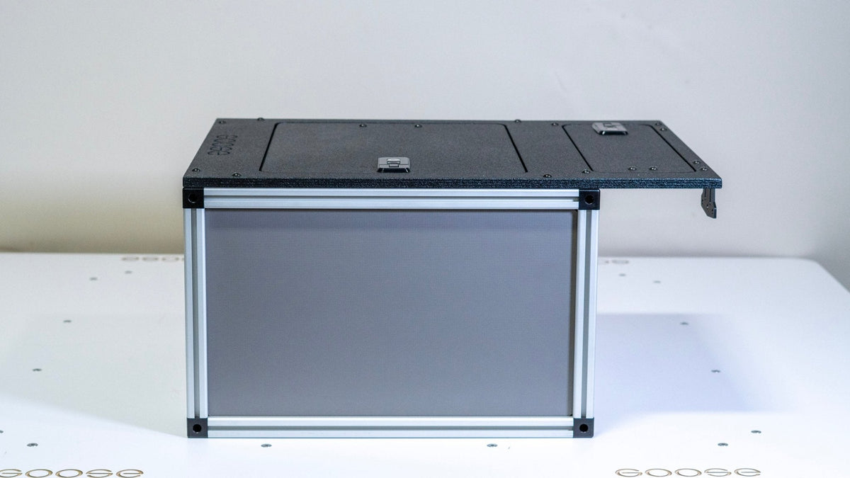 Goose Gear camper system front utility module for a midsize truck bed, aluminum frame with gray panel, side view