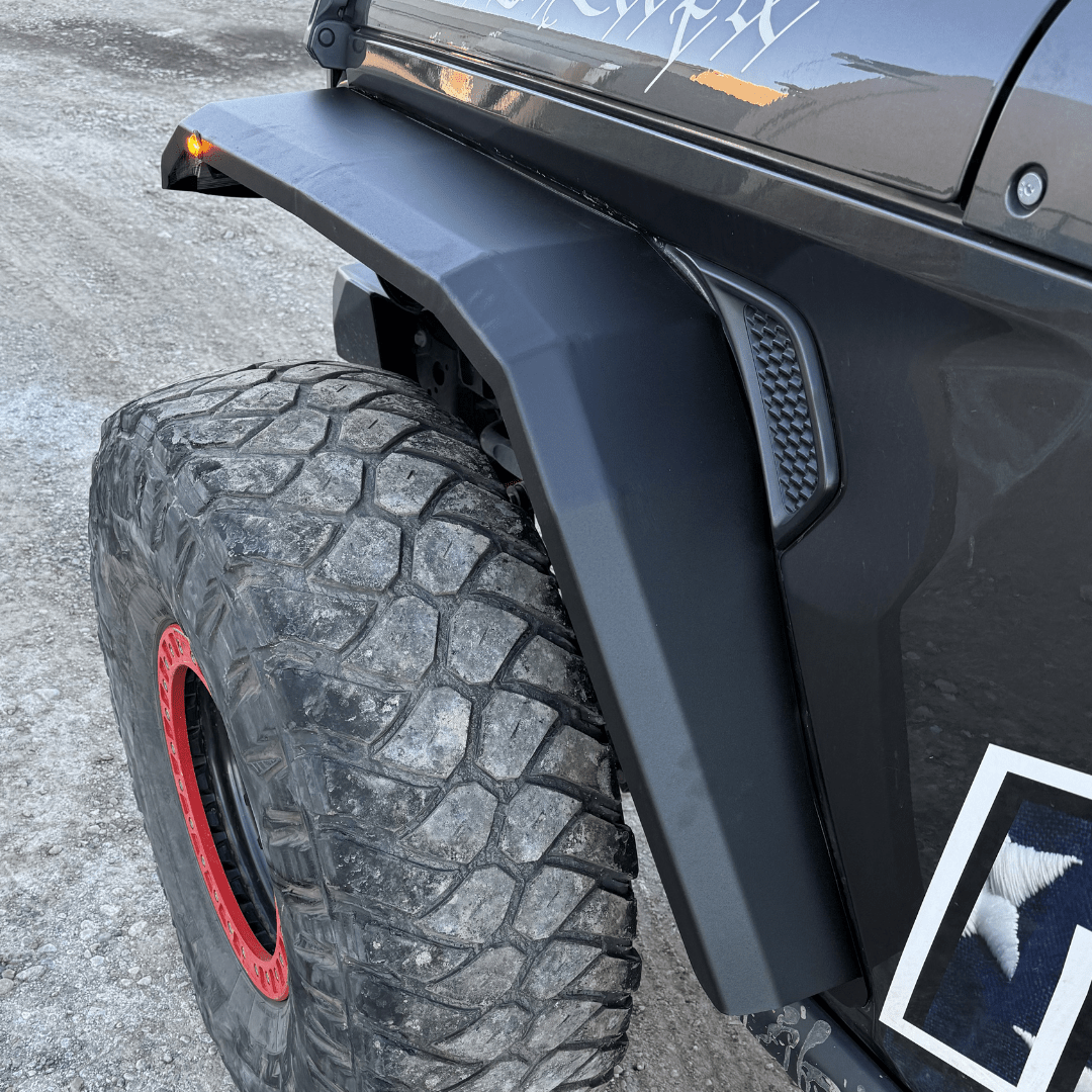 Close-up of off-road Jeep Wrangler front fender with rugged all-terrain tire