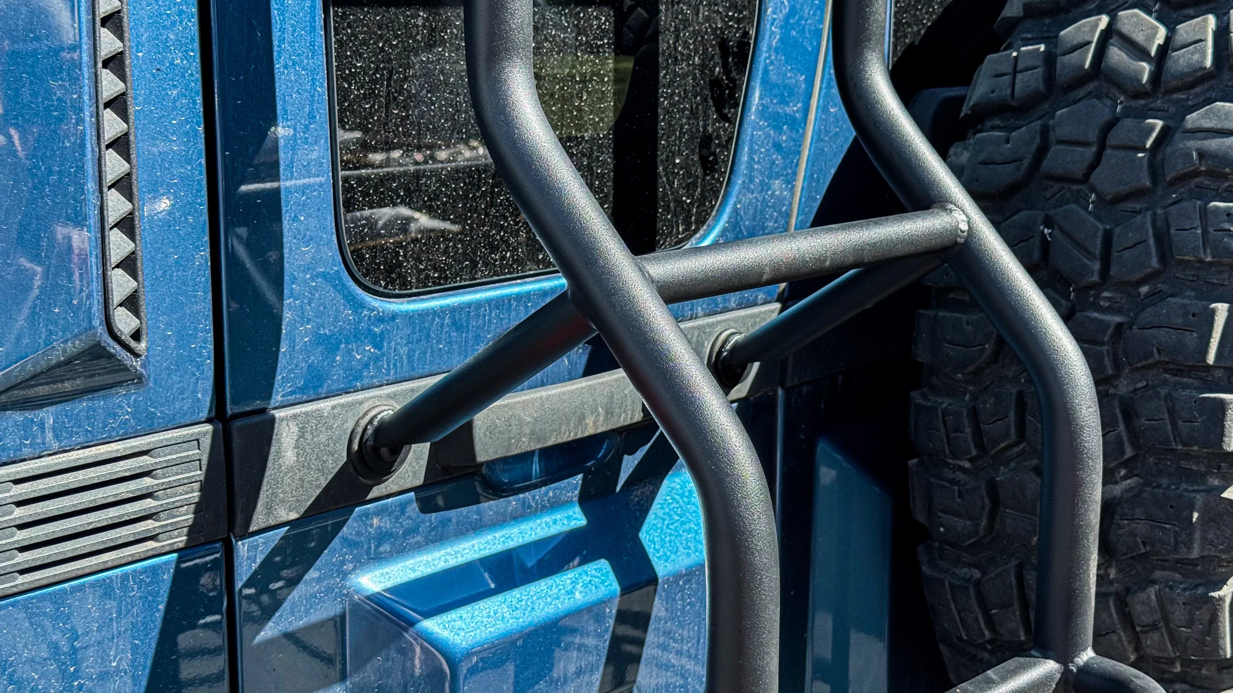INEOS Grenadier rear ladder with factory mounting points on blue off-road vehicle