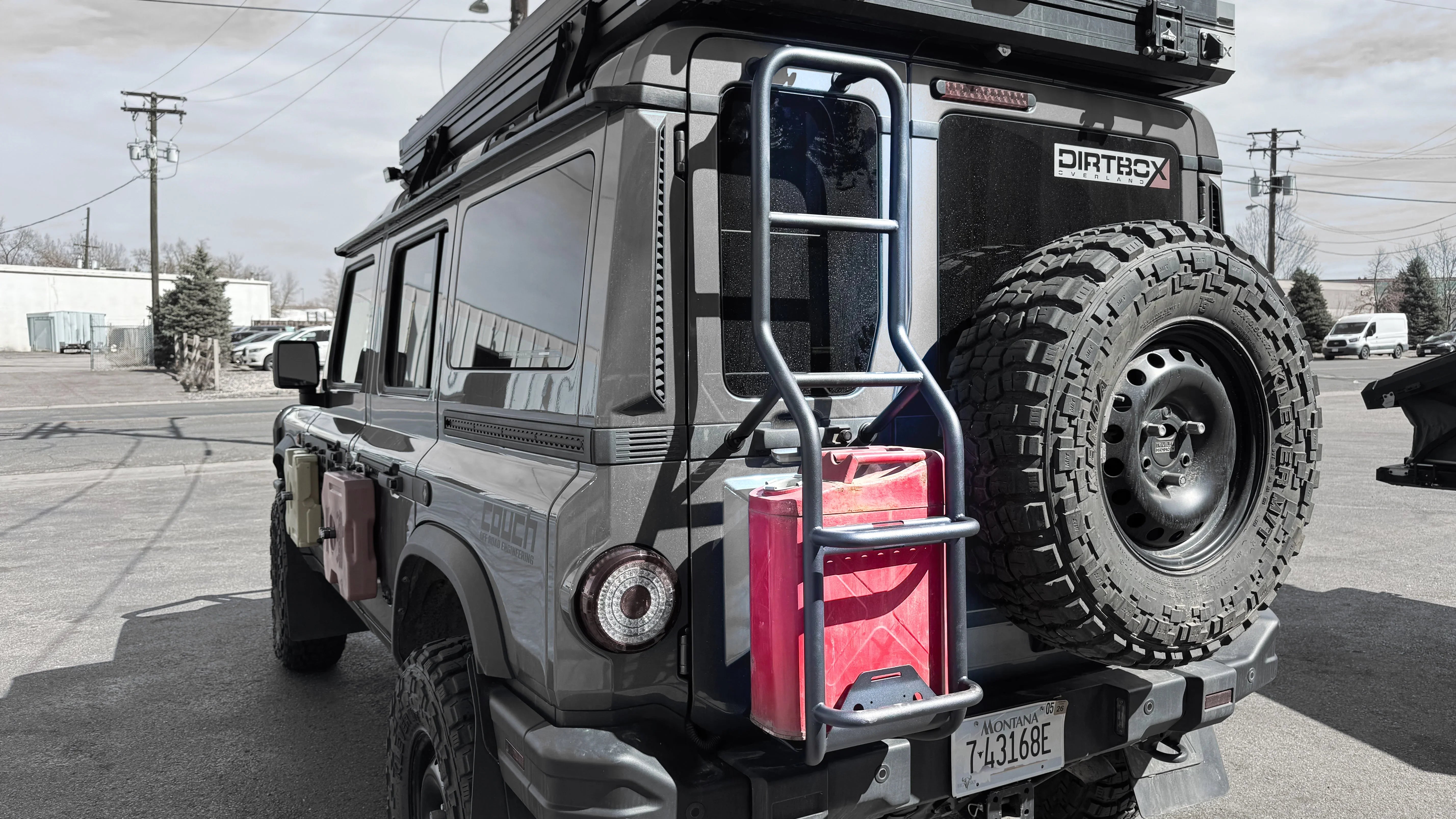 INEOS Grenadier rear ladder with mounted red jerry can and off-road spare tire