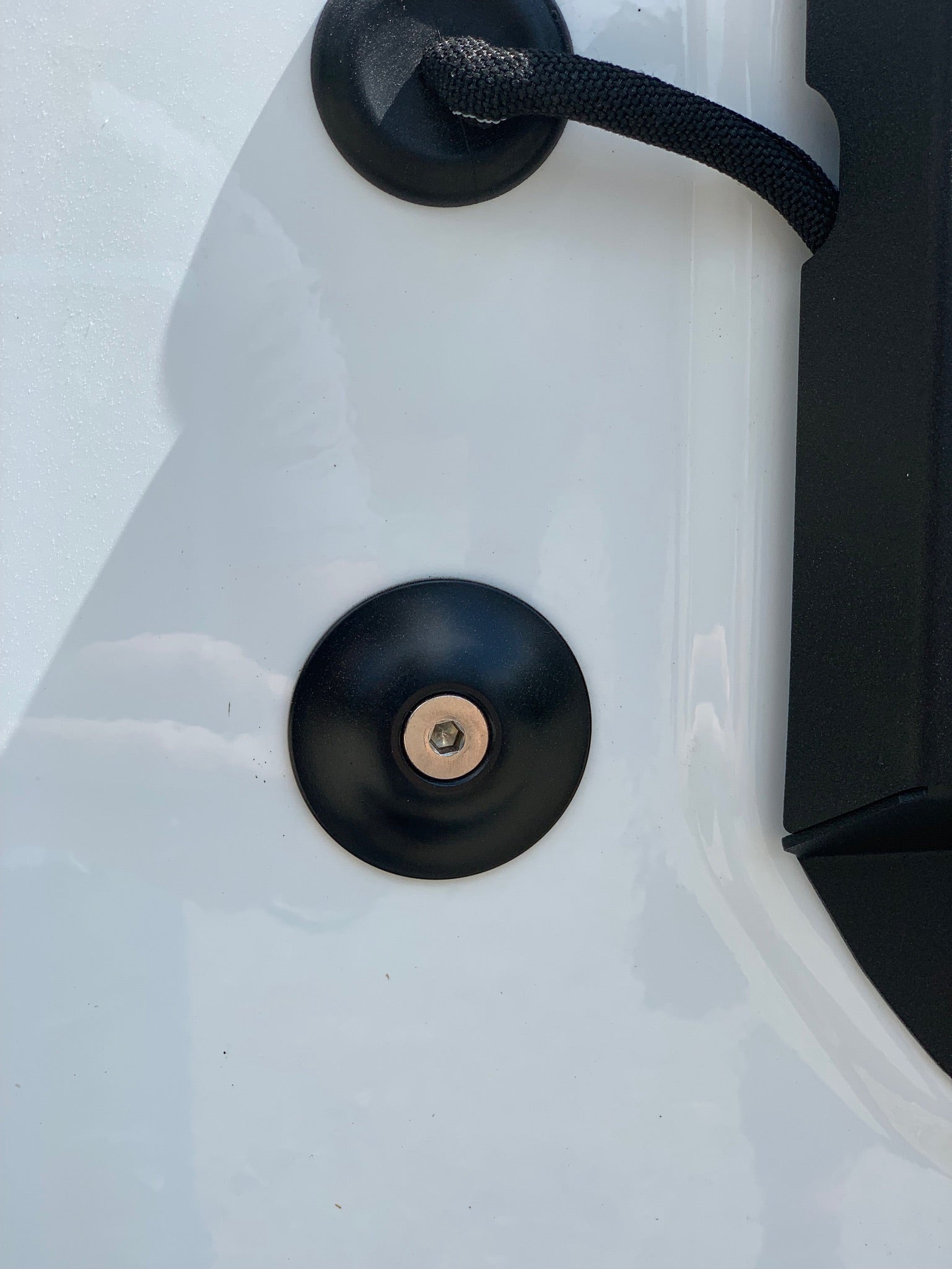 Jeep Wrangler JL tailgate desnubber installed on white vehicle door