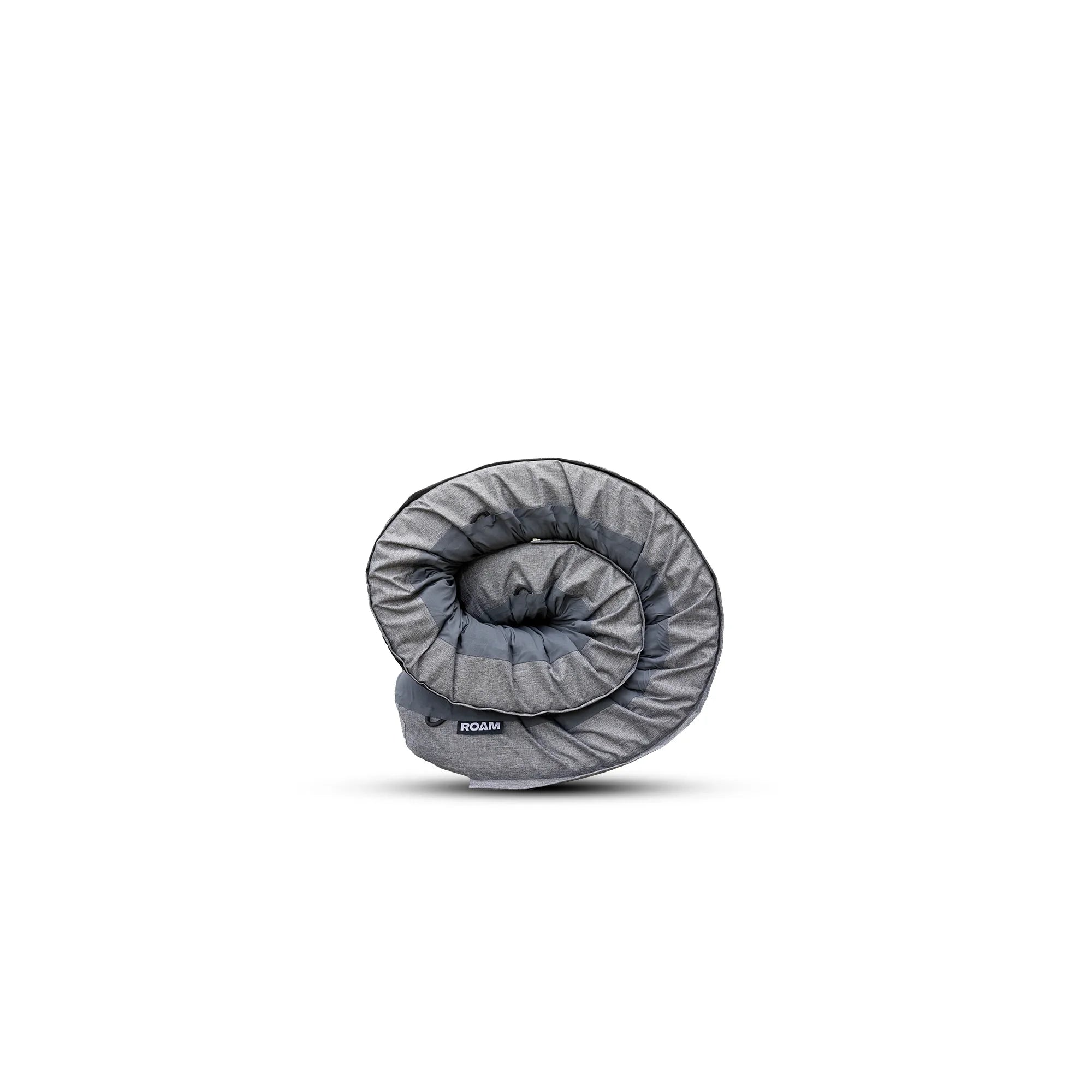 Rolled gray camping sleeping bag for overlanding and adventure vehicles on white background