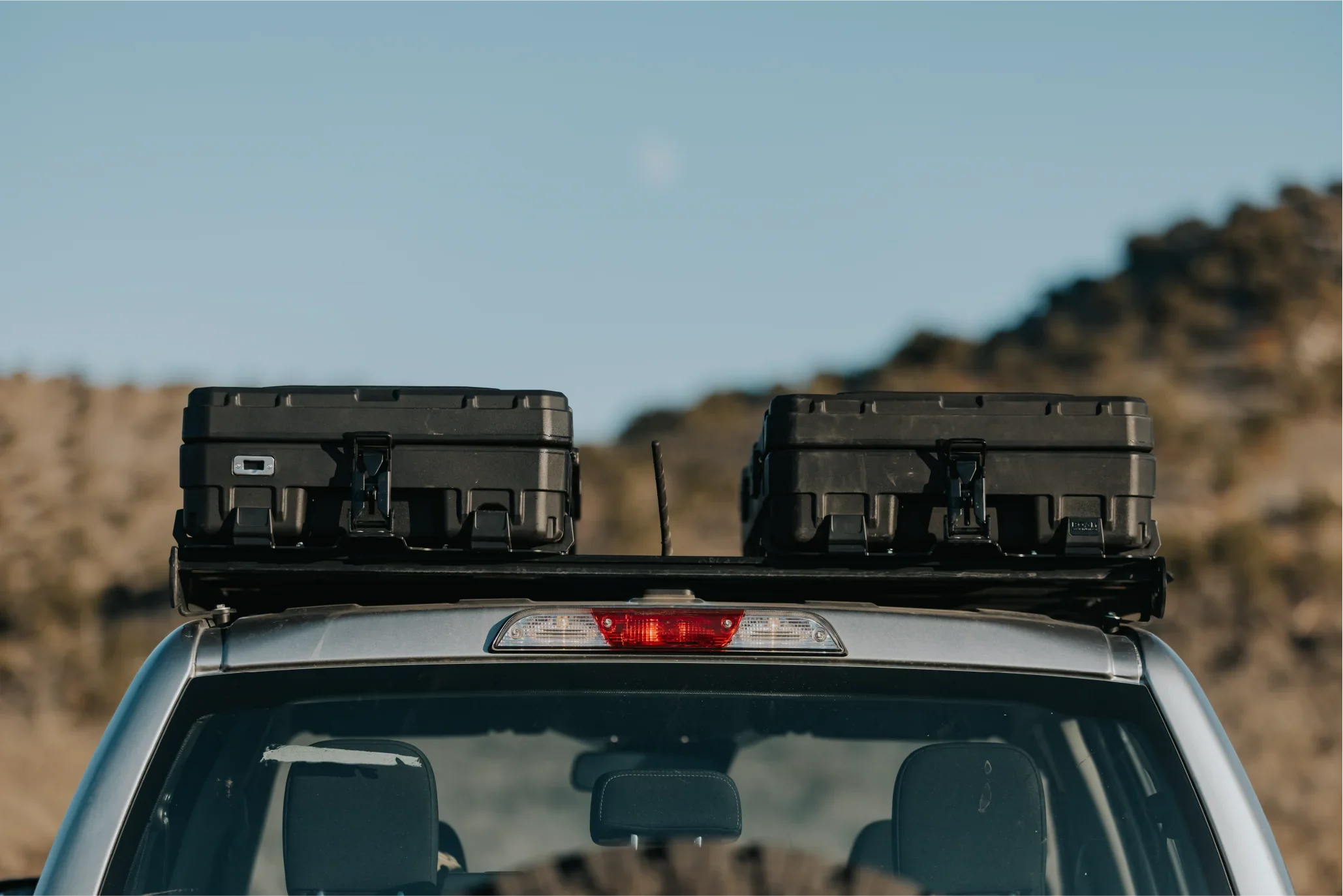 Rugged rooftop cargo boxes mounted on a vehicle for overlanding and expedition gear storage