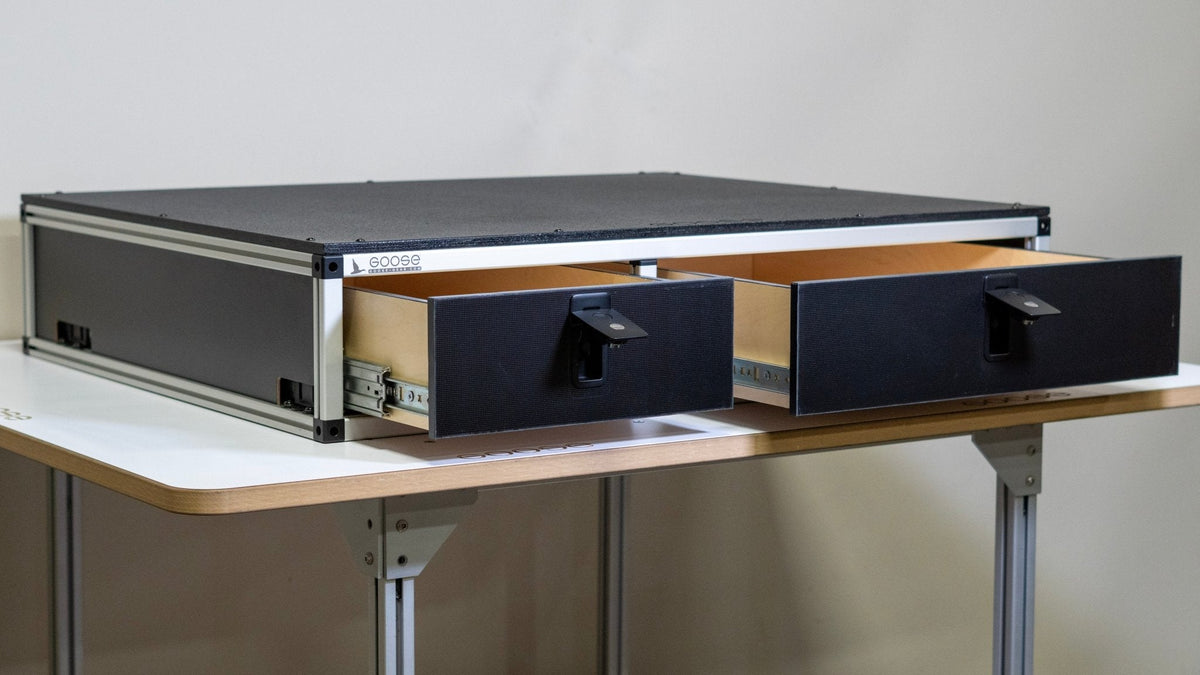 Goose Gear side-by-side drawer module from the side with both drawers partly open on a white table