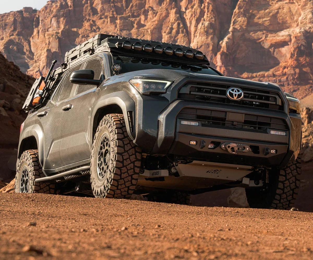 Toyota 4Runner with off-road accessories and gear parked in a rugged canyon landscape