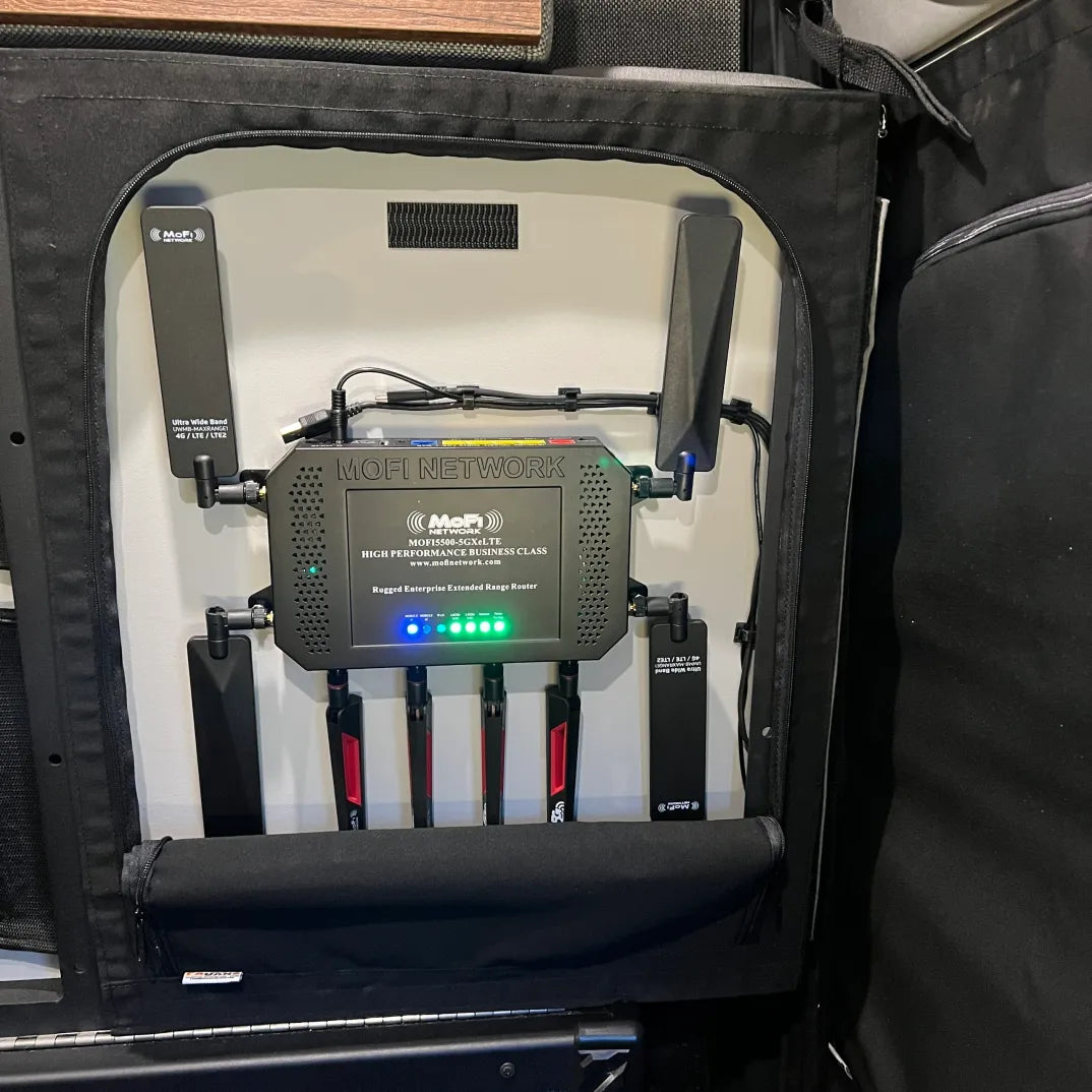 MOFI Network rugged enterprise extended range WiFi router with multiple antennas installed in a vehicle camping setup.