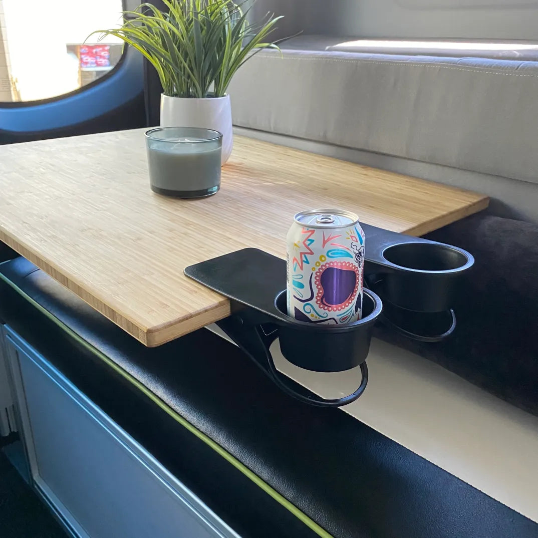 Van interior table with clip-on cup holder, soda can, candle, and potted plant