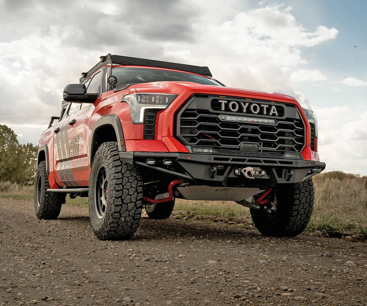 Lifted Toyota Tundra with off-road upgrades and accessories parked on gravel road