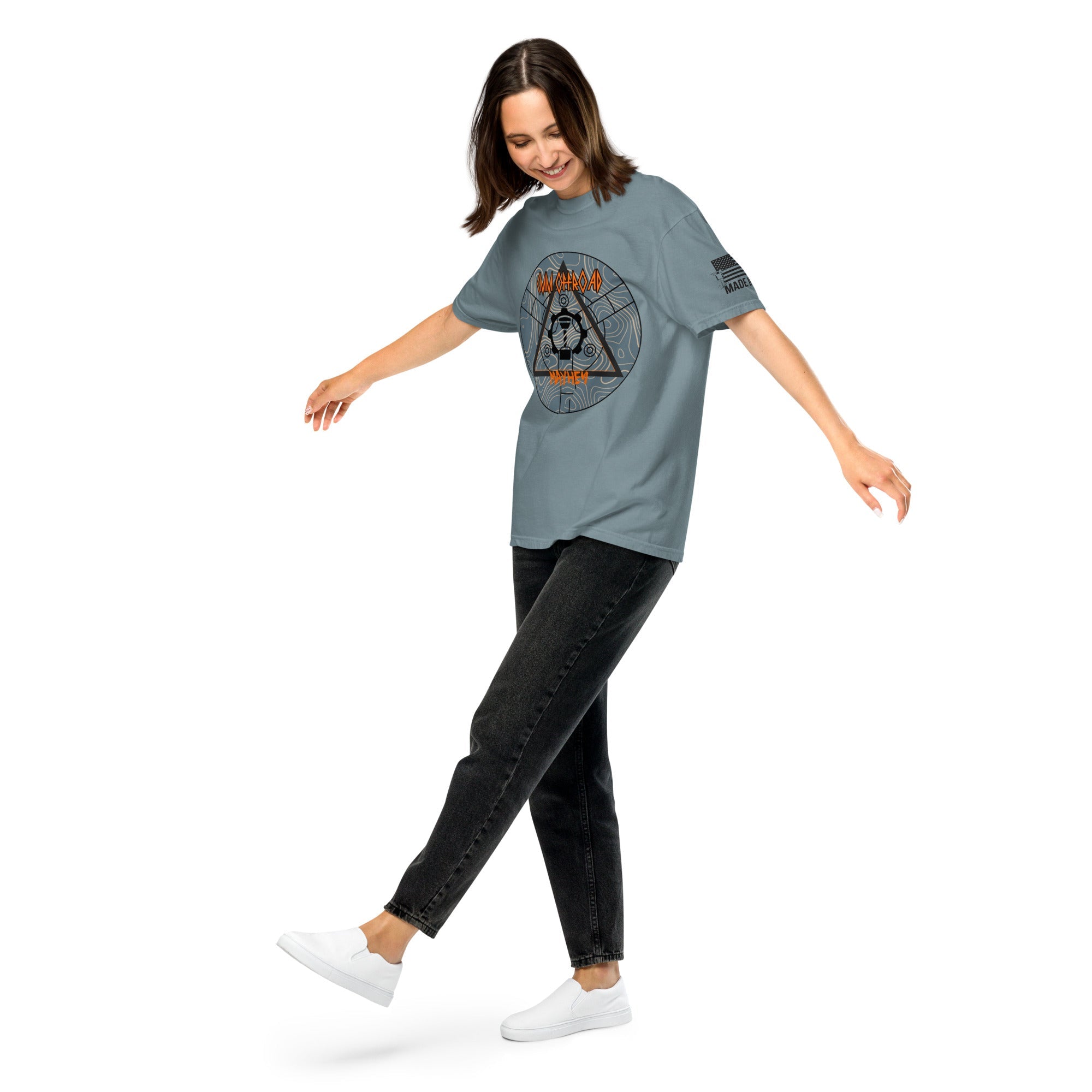 Woman wearing ice blue unisex heavyweight t-shirt with geometric graphic and black jeans