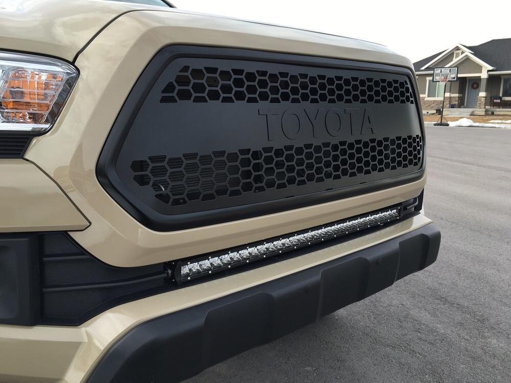 Toyota Tacoma front grille with honeycomb design and aftermarket LED light bar