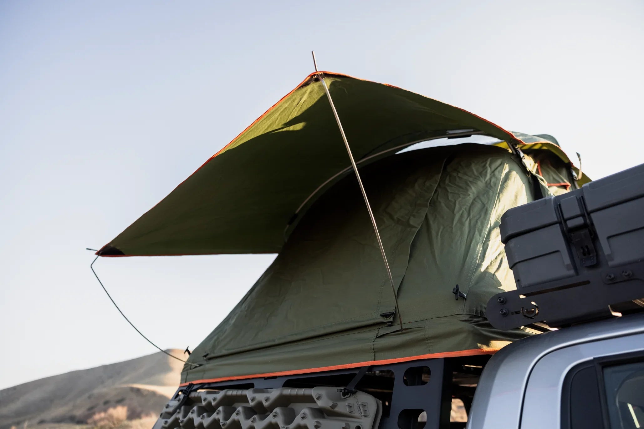 Roof top tent mounted on vehicle with gear box for overlanding and expedition camping