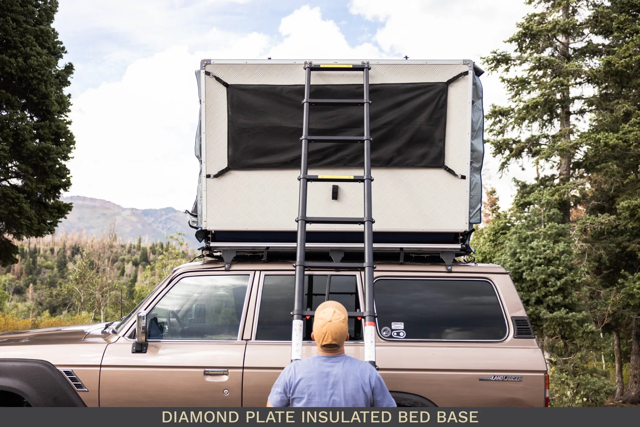 Vehicle with rooftop diamond plate insulated bed base and ladder in outdoor setting
