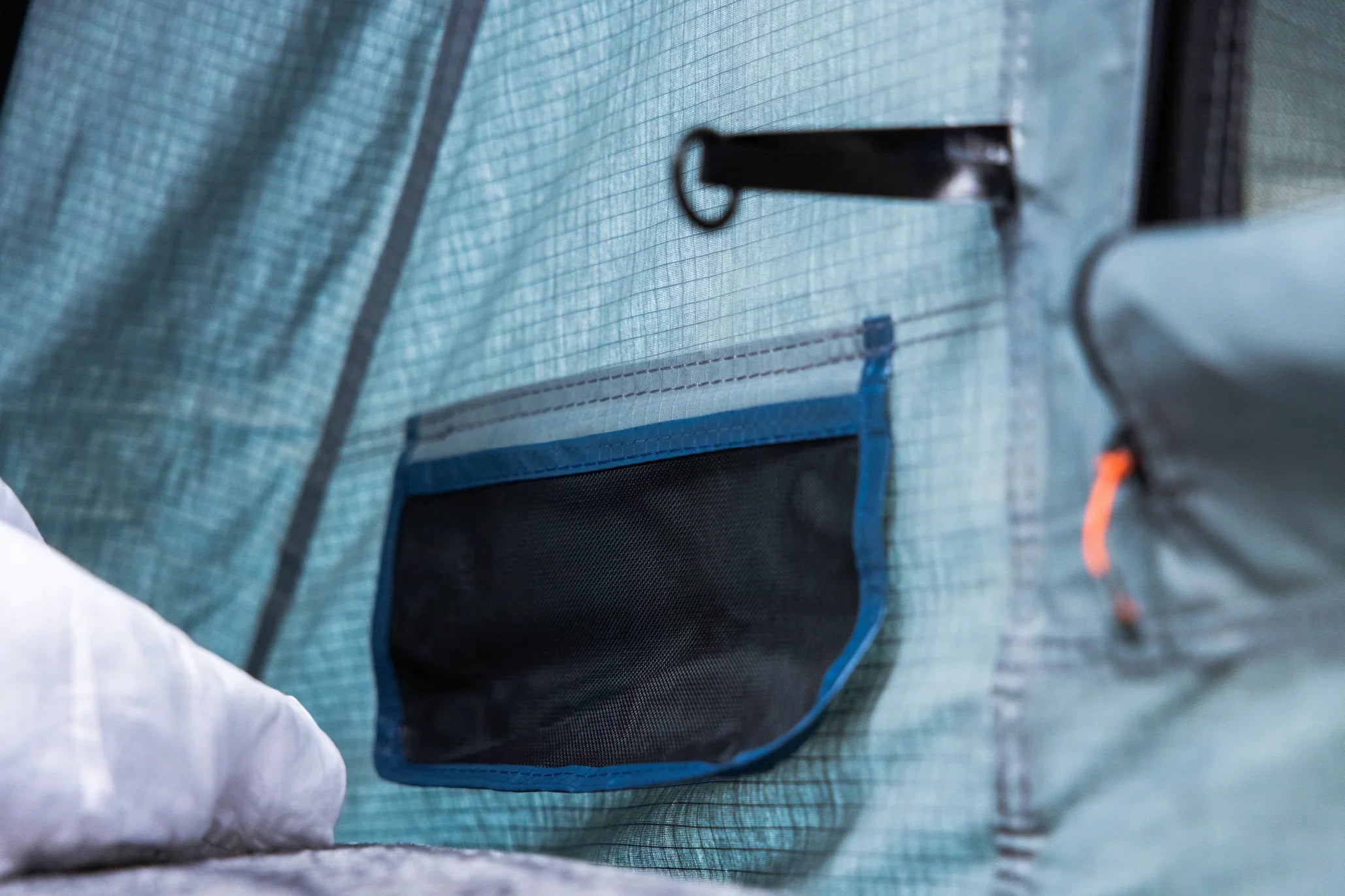 Close-up of mesh storage pocket inside outdoor camping tent with durable stitching